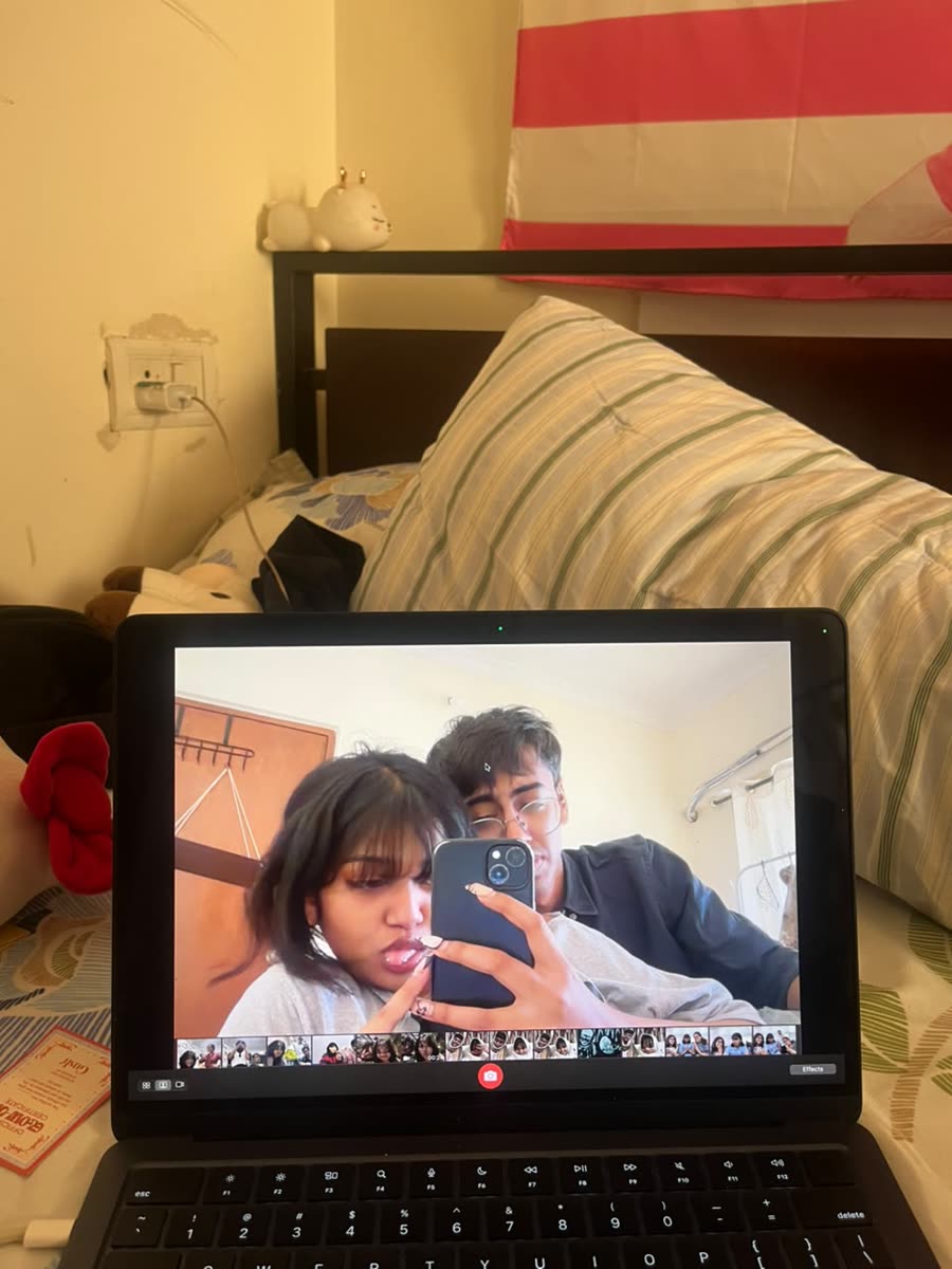 Anamika and Devansh in a mirror selfie shown on a laptop screen