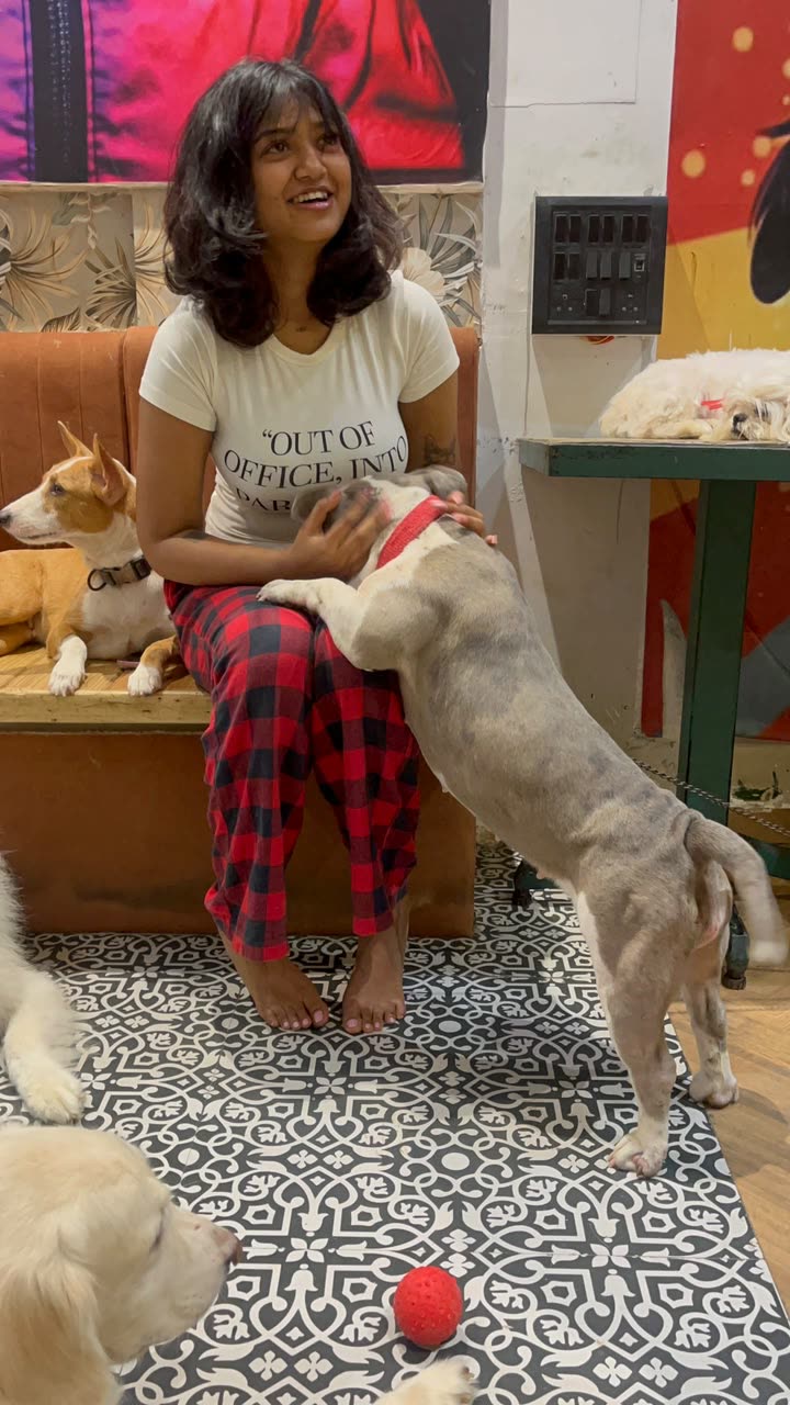 Anamika laughing at a dog cafe
